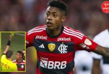 Bruno Henrique holding a yellow card or celebrating