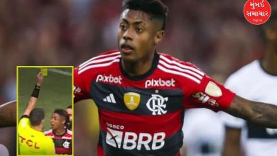 Bruno Henrique holding a yellow card or celebrating
