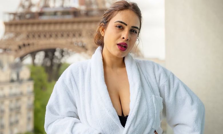 Neha Malik in a bathrobe strikes a killer pose on a balcony in Paris