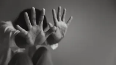A police station exterior in Pune with blurred figures of women walking away.
