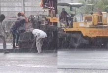 "Rajkot Municipal Corporation Builds Road in Heavy Rain"