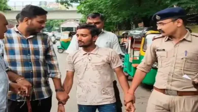 A young man being arrested by police officers.