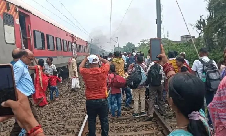 ઝારખંડના જામતાડામાં ટ્રેનના કોચમાં લાગેલી આગ. રેલવે કર્મચારીઓ ફાયર એક્સટિંગ્વિશરથી આગ બુઝાવી રહ્યા છે, જ્યારે પ્રવાસીઓ ટ્રેનથી દૂર ઊભા છે.