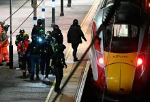 Police at the scene after a knife attack on a London-bound train, where nine people were seriously injured.