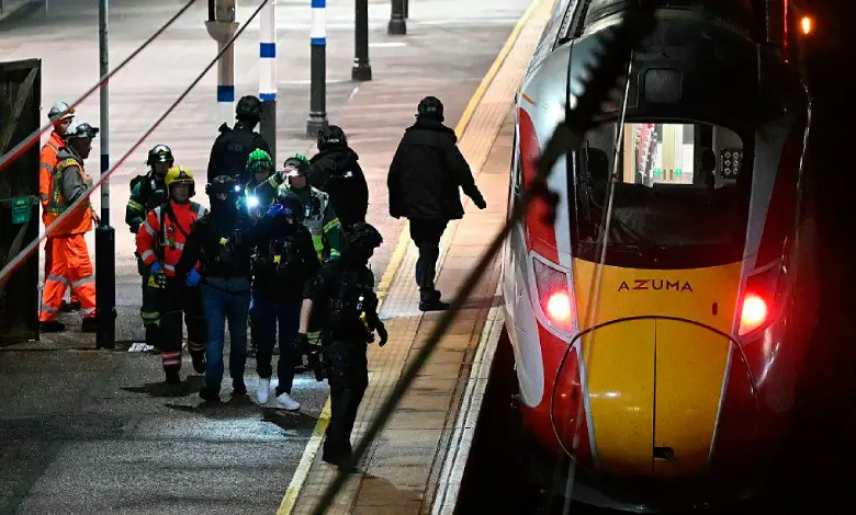 Police at the scene after a knife attack on a London-bound train, where nine people were seriously injured.