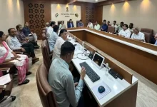 Gujarat election officials discussing SIR digitalization progress during a meeting with political party representatives