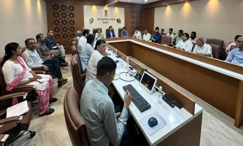 Gujarat election officials discussing SIR digitalization progress during a meeting with political party representatives