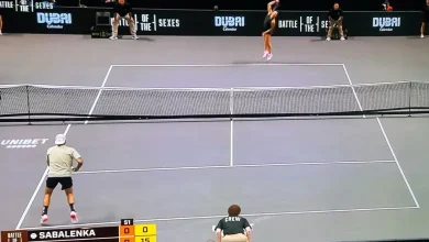 Nick Kyrgios and Aryna Sabalenka laughing during Battle of the Sexes match in Dubai.