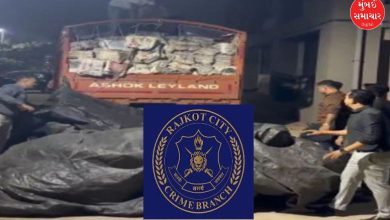 Crime Branch officers inspect seized liquor from an icer truck rajkot