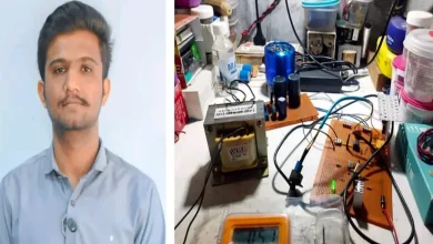 Engineering students showcasing EV battery charger prototype