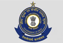 A worker sorting export parcels at a Dak Niryat Kendra with India Post and CBIC branding.