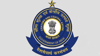 A worker sorting export parcels at a Dak Niryat Kendra with India Post and CBIC branding.