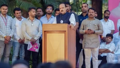 Dada Pawar holding the saffron flag of Shiv Sena UBT with Uddhav Thackeray's image.