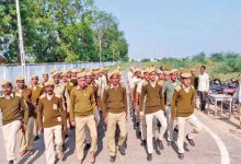 Gujarat Home Guard personnel standing in formation during a state parade.