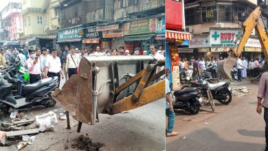 BMC workers and machinery removing illegal structures from footpaths at Mohammed Ali Road